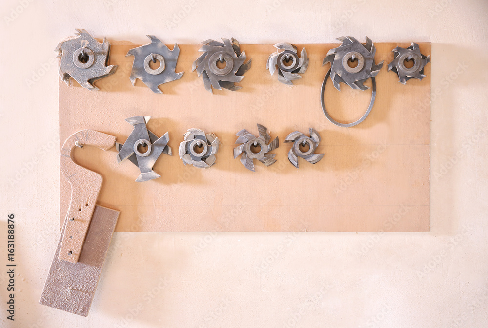 Stand with milling cutters on wall in carpenter's workshop