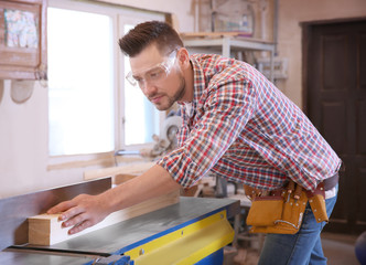 Wall Mural - Carpenter preparing timber on table saw