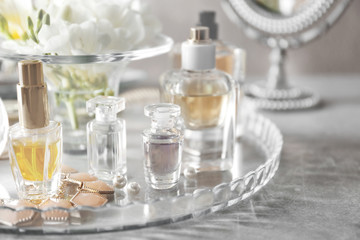 Wall Mural - Glass tray with perfume bottles on grey table