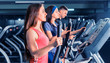 © kolotype - Group of young people diligently exercising on the crosstrainer machines