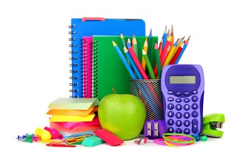 Books and a colorful group of school supplies isolated on a white background