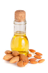 Wall Mural - Bottle of almond oil and almonds isolated on white background