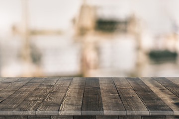 Wall Mural - Empty wooden table for product placement or montage with focus to table top in the foreground, with white background. Wooden board empty table perspective.