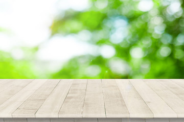 Wall Mural - empty wooden table for product placement or montage with focus to table top in the foreground, with 