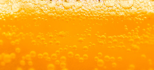 Wall Mural - bubble beer close up / yellow background / water / drink