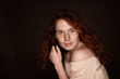 © LIGHTFIELD STUDIOS - pretty sensual redhead woman posing in beige blouse, isolated on black with copy space