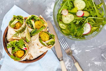 Wall Mural - Vegan falafel wraps with salad and hummus. Love for a healthy vegan food concept.