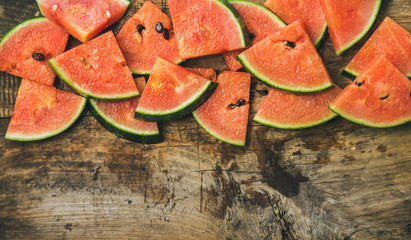 Wall Mural - Fresh summer fruit food frame. Juicy watermelon pieces over rustic wooden background, top view, copy space
