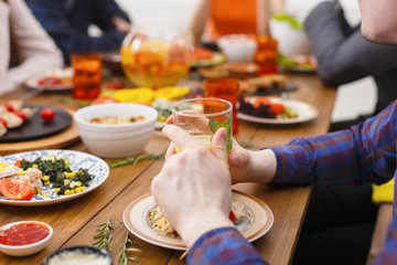 Served table for dinner. Hands with glass