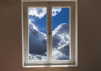  Closed window and a view of a clouds on a sunny day