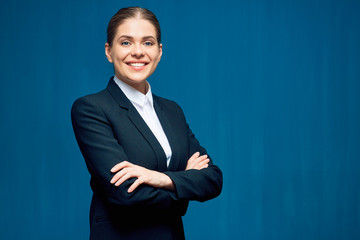 Smiling business woman standing with crossed arms.