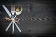 Spoon knife fork tied on dark background