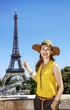 © Alliance - happy woman pointing on Eiffel tower in Paris