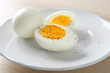 White ceramic plate with hard boiled eggs on light table. Nutrition concept