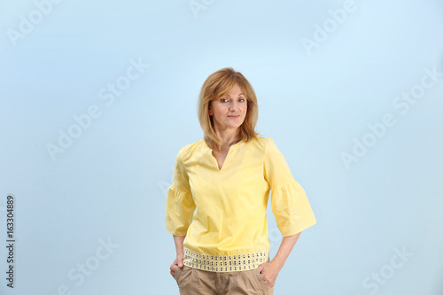 Portrait Of Attractive Mature Woman On Light Blue Background Buy