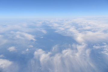 Wall Mural - Aerial view of white clouds in the blue sky, Beautiful view from airplane window