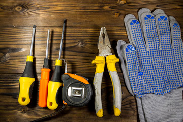 Set of work tools on wooden background