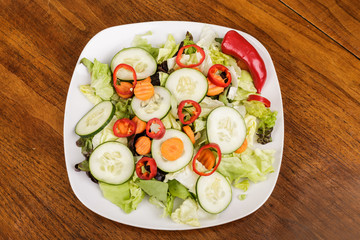 Wall Mural - Red Peppers on Green Salad