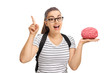 Teenage student holding a brain model and gesturing