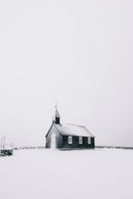 Beautiful Minimalistic View Of Budir Black Church In The Snaefellsnes Peninsula During Severe Snowstorm