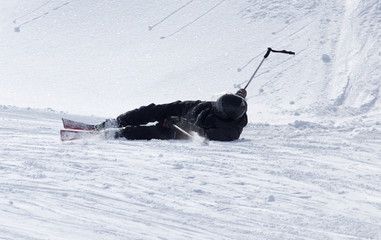 The skier fell in the snow at speed