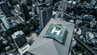 Aerial drone top view of helipad isolated on top of the skycraper in Bangkok city