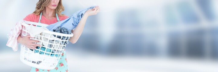 Wall Mural - Cleaner  holding laundry basket with bright background