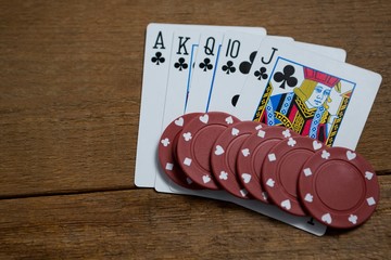 Overhead view of cards and maroon chips