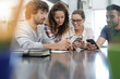 © goodluz - Group of young people playing with smartphones