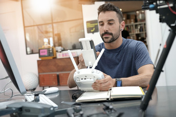 Engineer working on drone in lab