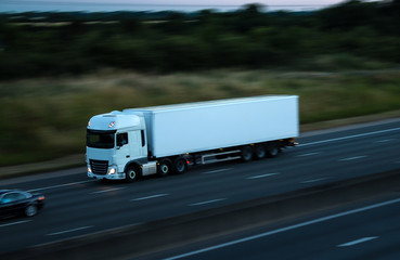 Road traffic - white lorry at the dusk time