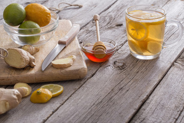 Wall Mural -  Ginger tea and ingredients on a  grunge wooden background