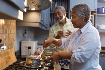 Wall Mural - Happy senior couple preparing food home