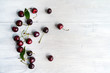 © Studio Dagdagaz - Summer food background - ripe cherry berries on white wooden table. Copy space.