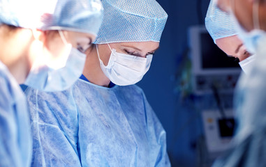 Wall Mural - group of surgeons in operating room at hospital