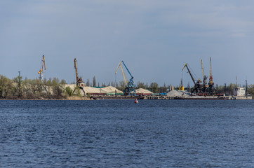 Cranes in cargo port on a river Dnieper in Kremenchug, Ukraine