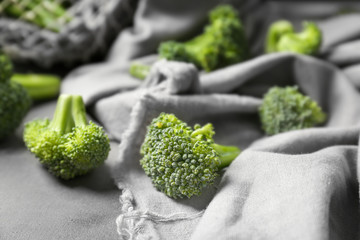 Wall Mural - Tasty fresh broccoli on grey cloth, closeup