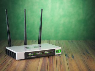 Leinwandbilder - Wi-Fi wireless internet router on the wooden table and green background.