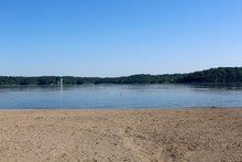 The View Of The Lake From The Waters Edge On The Beach.