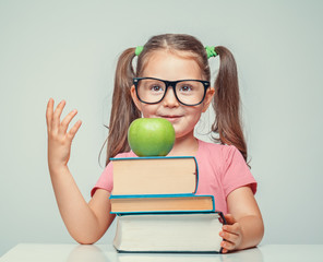 Wall Mural - beautiful cute little girl with green apple and thick books
