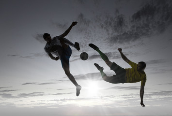 Silhouettes of two soccer players