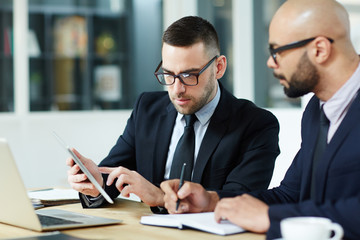 Wall Mural - Modern analyst making presentation of data to colleague