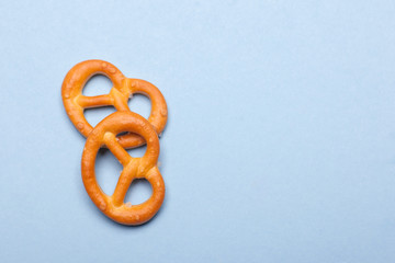 two mini pretzels bakery isolated on blue background with copy space