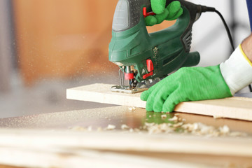 Wall Mural - Carpenter working with jigsaw, closeup