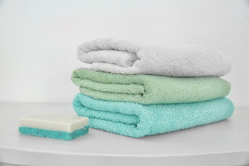 Wall Mural - Stack of clean towels and soap on table