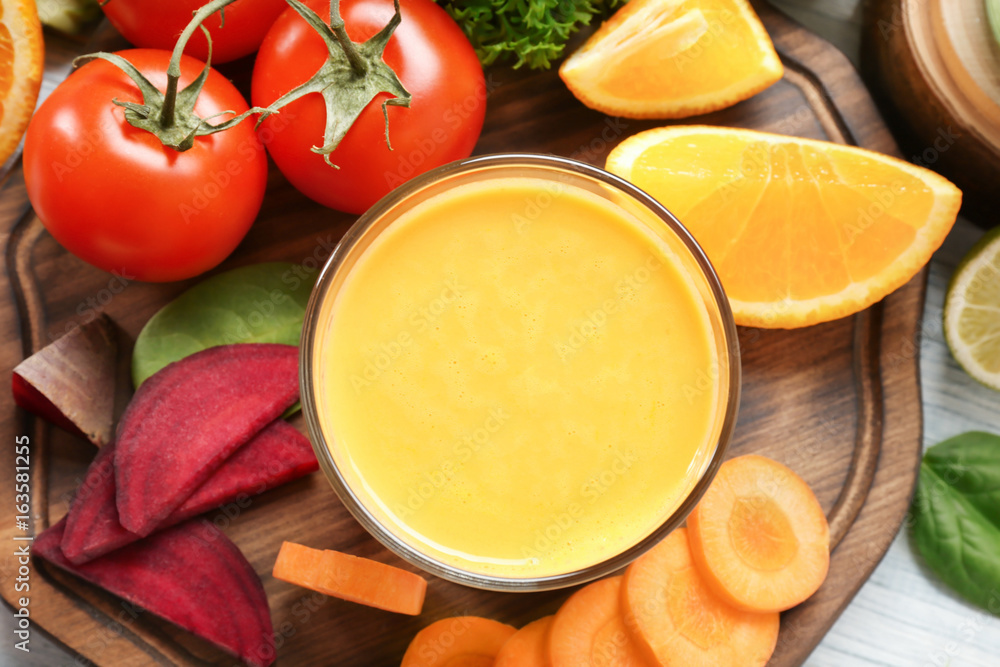 Fresh smoothie, vegetables and fruits on wooden board