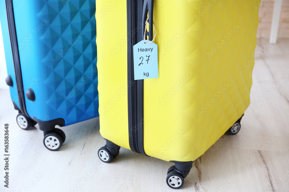 Tag on heavy suitcase. Luggage overweight concept