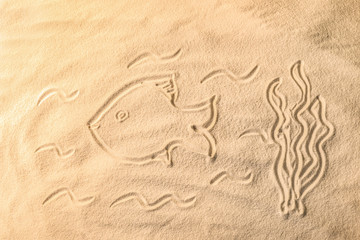 Sticker - Fish drawn on sea sand, closeup view