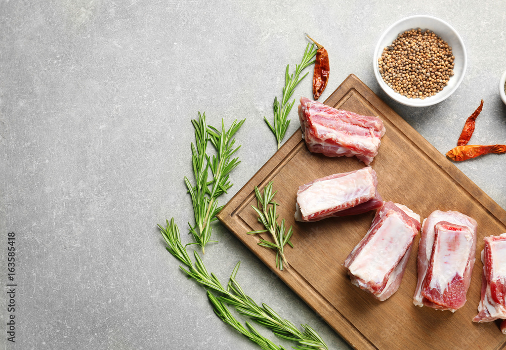Raw ribs with spices on kitchen table