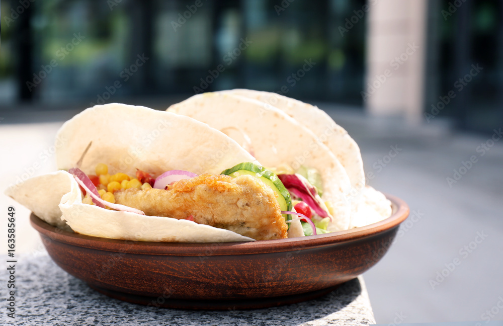 Plate with delicious fish tacos outdoor